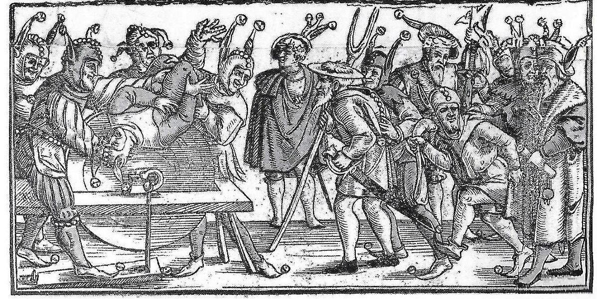 Fool held to grindstone by fellow fools